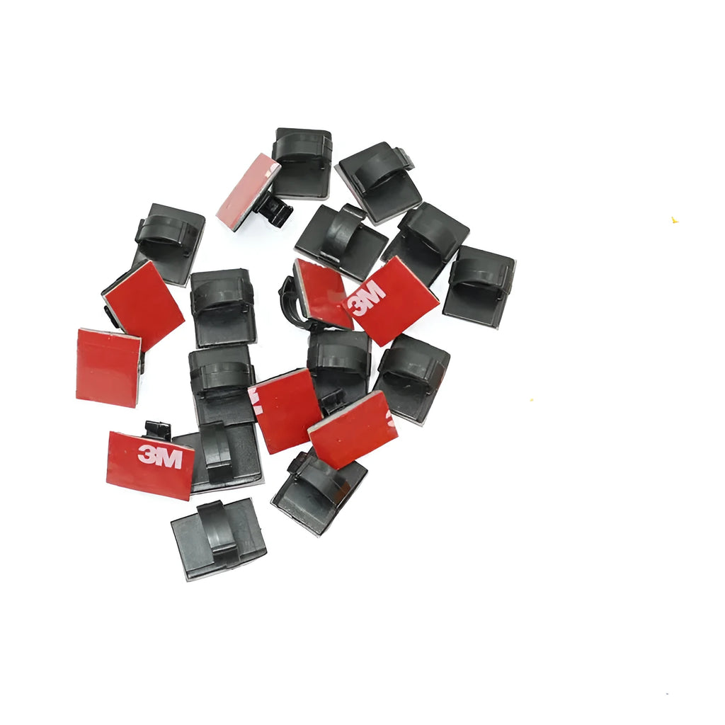 Black and white self-adhesive plastic clamps for organising car wiring cables.