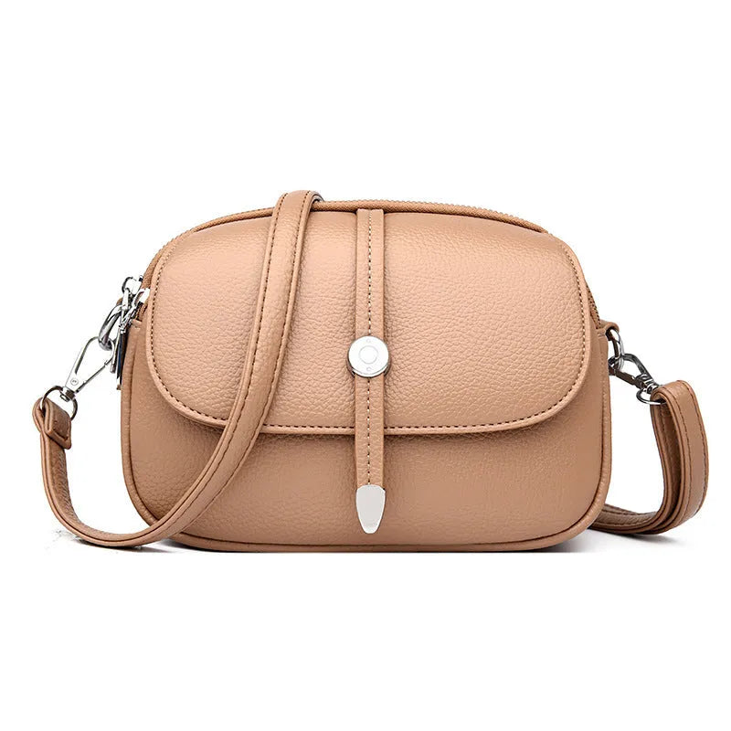 Women's crossbody shoulder bag in oval suitcase shape with soft PU construction