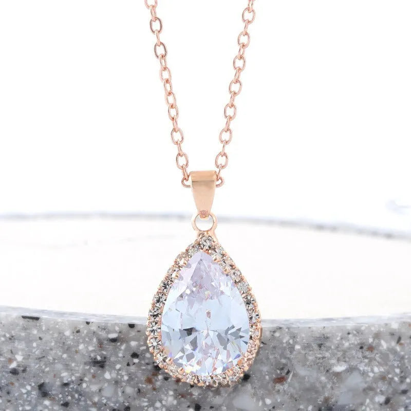 Women's pink alloy water drop necklace with geometric design and rose gold rhinestones on model