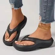 Women's thick-soled flip flops with non-slip textured soles in black, white, and grey colour options
