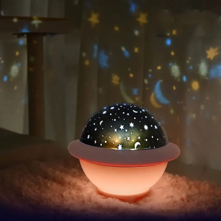 UFO-shaped plastic night light projecting starry sky pattern, available in green, pink, or white