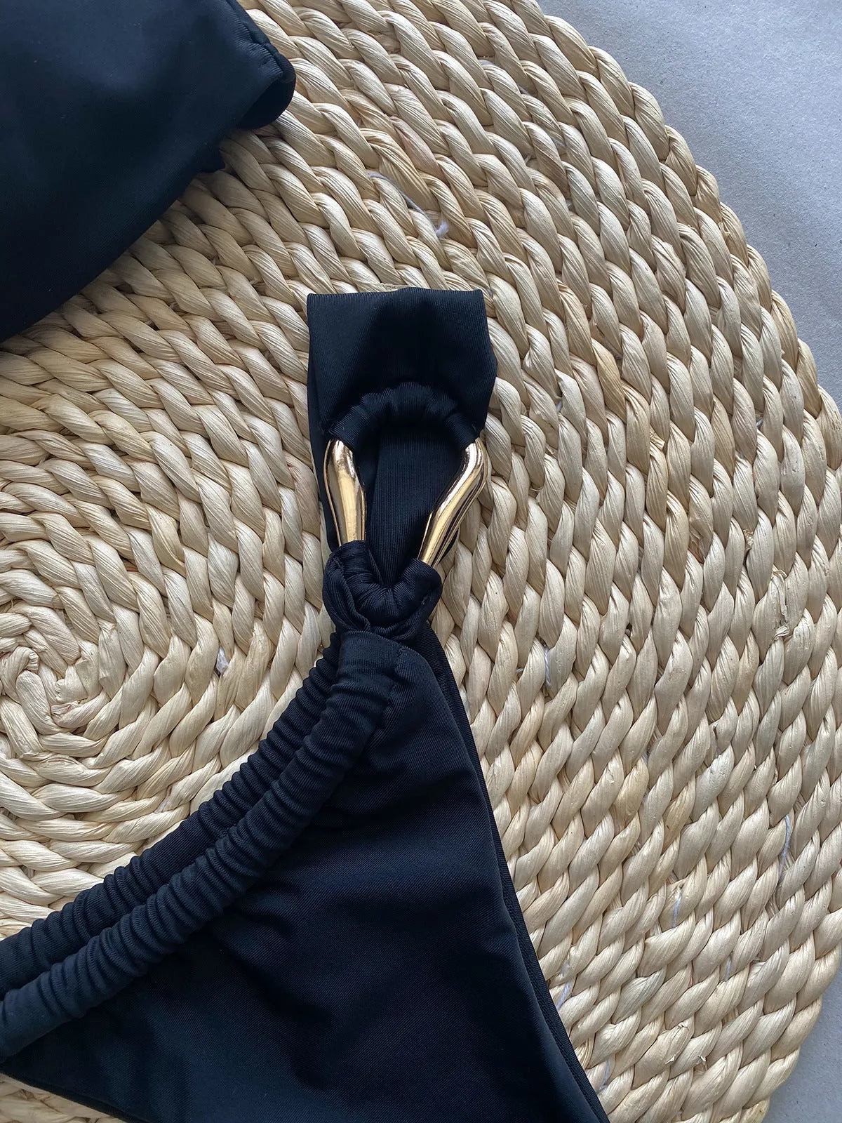 Black low waist bikini swimsuit set with split briefs, made from nylon.