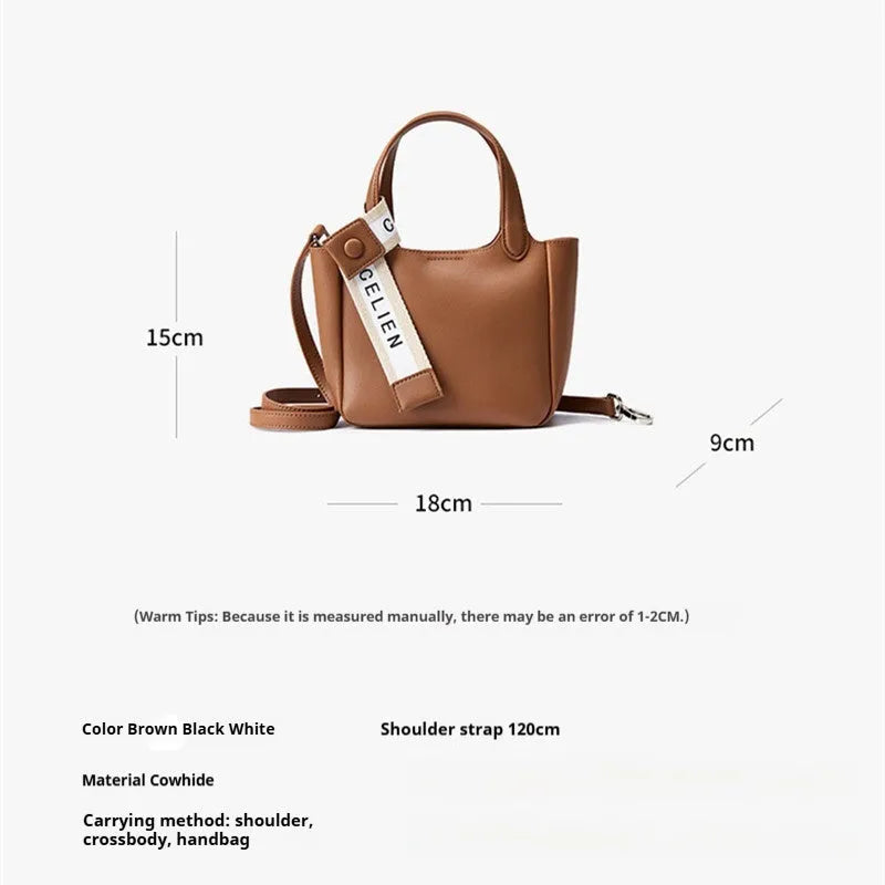 Brown cattlehide leather cross body bucket bag with square vertical shape and visible stitching