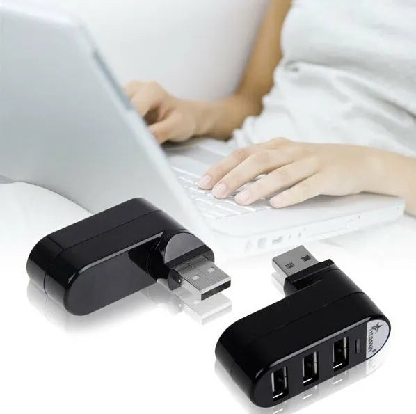 Black and white USB hub with a spinning multi-interface design on a desk.