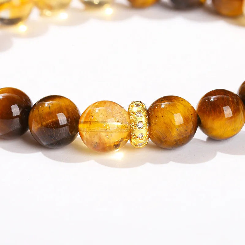Women's geometric bracelet with natural yellow tiger stone and yellow tower crystal beads on wrist.