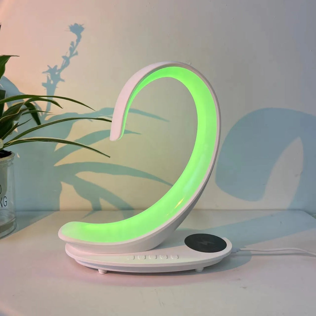 White swan decorative light with wireless charging pad and Bluetooth speaker emitting colourful illumination