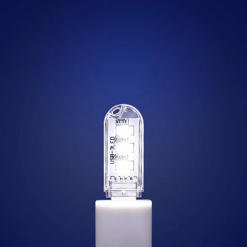 Small white USB-powered LED baby night light showing dual white and warm light options