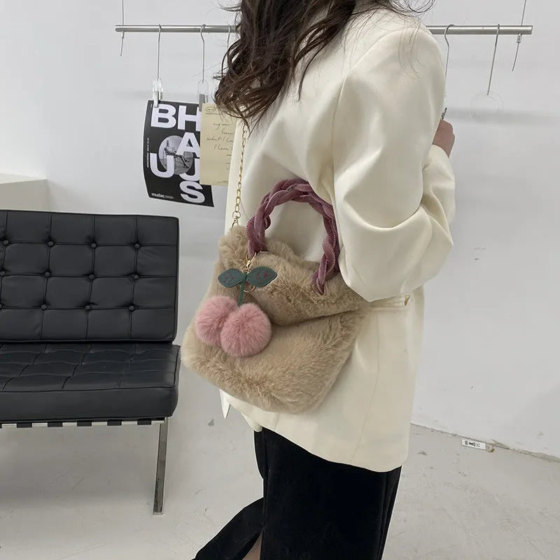 Large soft plush travel bucket bag in beige with open pocket and single shoulder strap