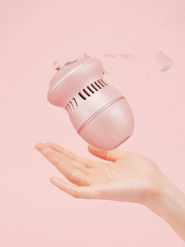 Beige and white USB-charged electric foot file grinder with vacuum system and two diamond grinding heads.