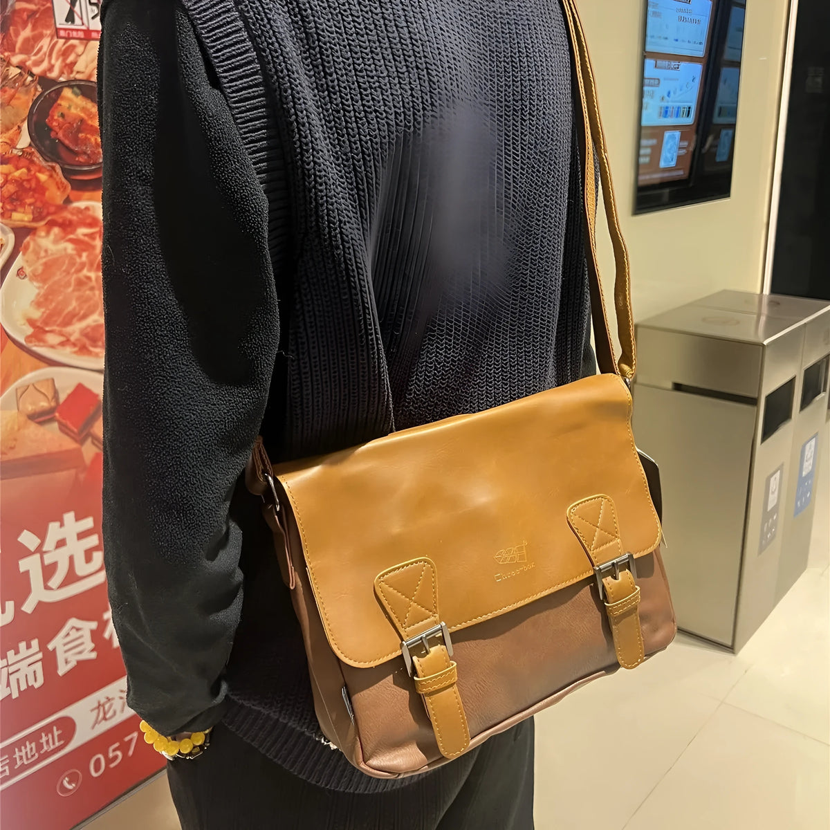 Retro men's messenger bag in light brown PU material with shoulder strap on neutral background