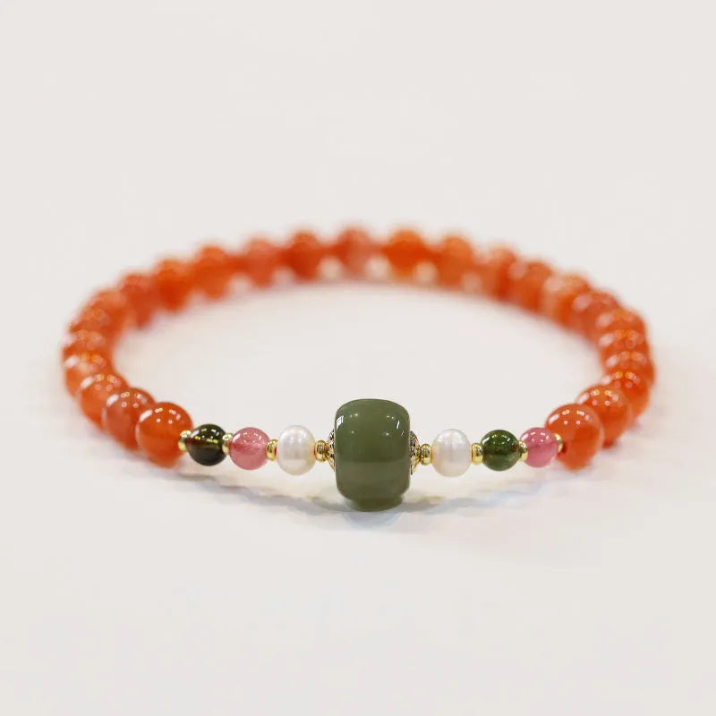 Close-up of a women's bracelet with round cherry red South Red Agate beads in a retro ethnic style.