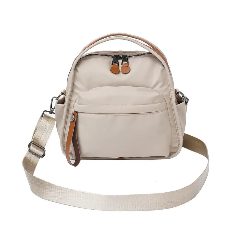 Nylon shoulder bag 25x11x23cm pillow shape with zippered compartment and outer pocket, available in brown, khaki, black, beige