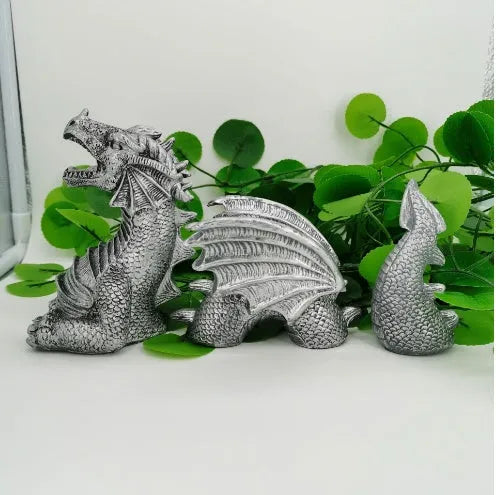 Large gothic dragon garden statue in charcoal gray stone with scales, wings, and tail, outdoor lawn decor
