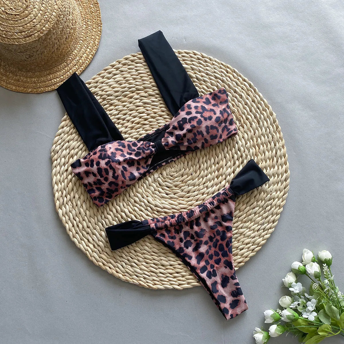 Women's leopard print tube top bikini set with matching T-pants on a mannequin.