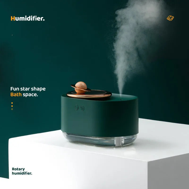 Green rotating planet humidifier with USB cable and 0.5L water tank on wooden desktop