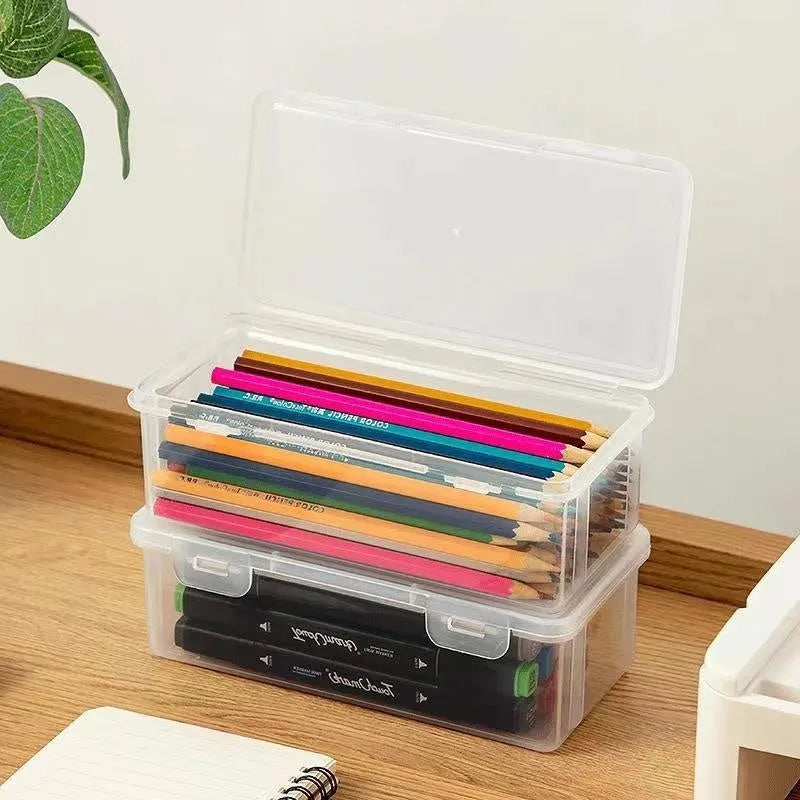 Transparent plastic pencil storage box for stationery organisation with visible drawing supplies inside