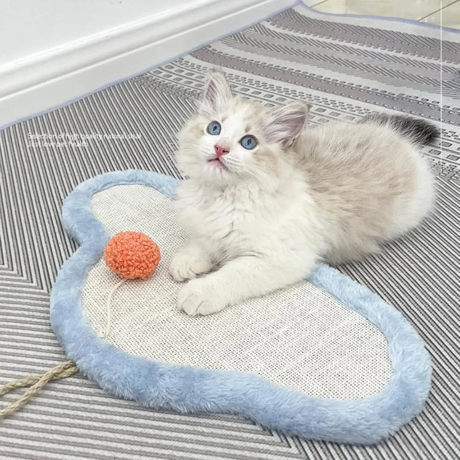 White wall-mounted cat scratching mat with sleeping cat cartoon design on natural sisal material