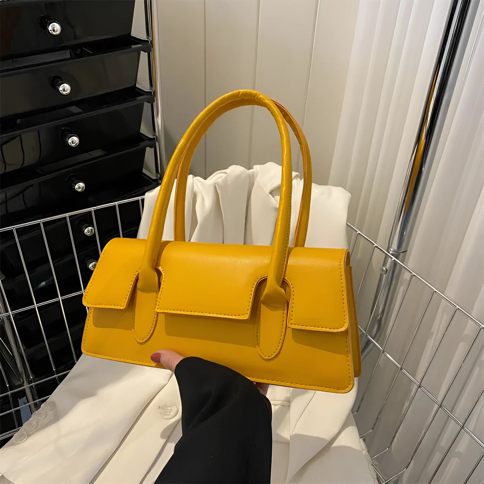 Women's square shoulder bag in black with stitching detail and single shoulder strap