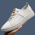 Beige and black men's round-toe cowhide sneakers with mesh lining and stitching detail.