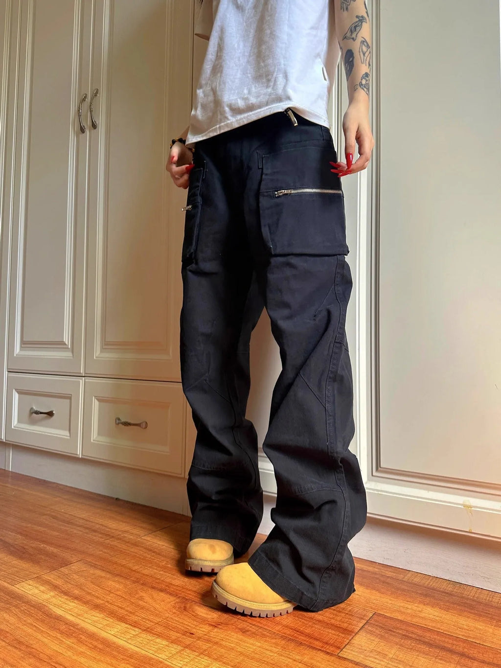 Green and black cotton casual trousers with double zipper detail and pockets on a mid-waist design.