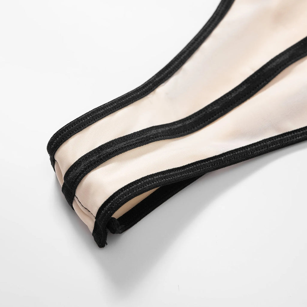 Khaki bodybuilding jumpsuit with sleeveless hollow-out top and contrast panels, worn with matching shorts.
