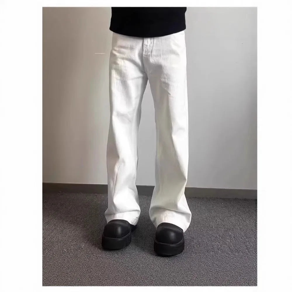 Men's white straight-leg cotton jeans with a wide-leg opening and zipper fly.