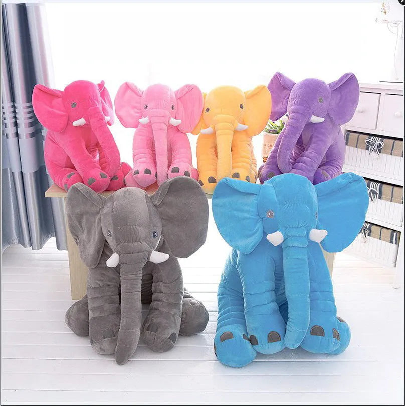Grey elephant-shaped plush pillow cover for a child's bed, shown alongside blue and pink versions.