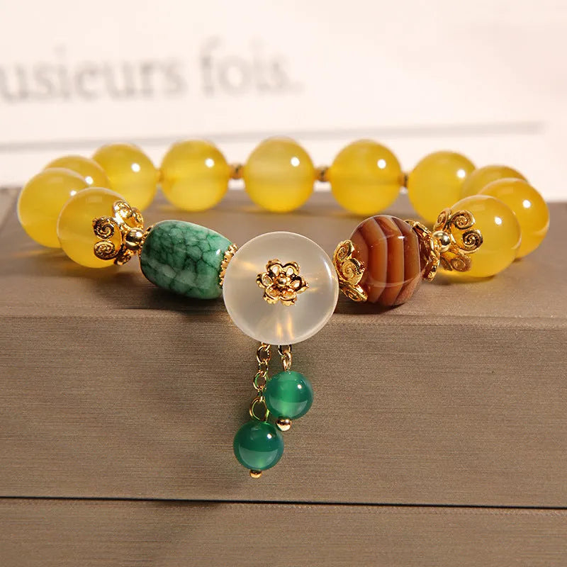 Khaki women's bracelet with yellow agate crystals threaded on a gold silk cord.