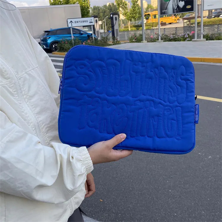 Embroidered blue silk laptop liner bag with letter pattern and cotton lining on a white background