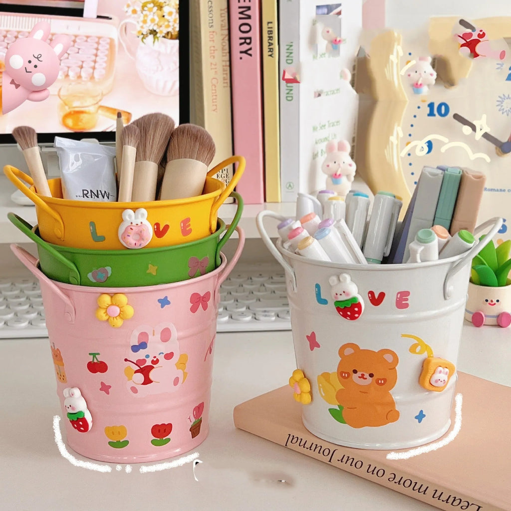 Round metal desk organiser pen holder in various colours including pink, green, red, white, and yellow.