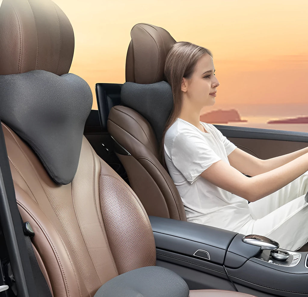 Dark grey car neck memory pillow on a headrest showing its simple rectangular shape.