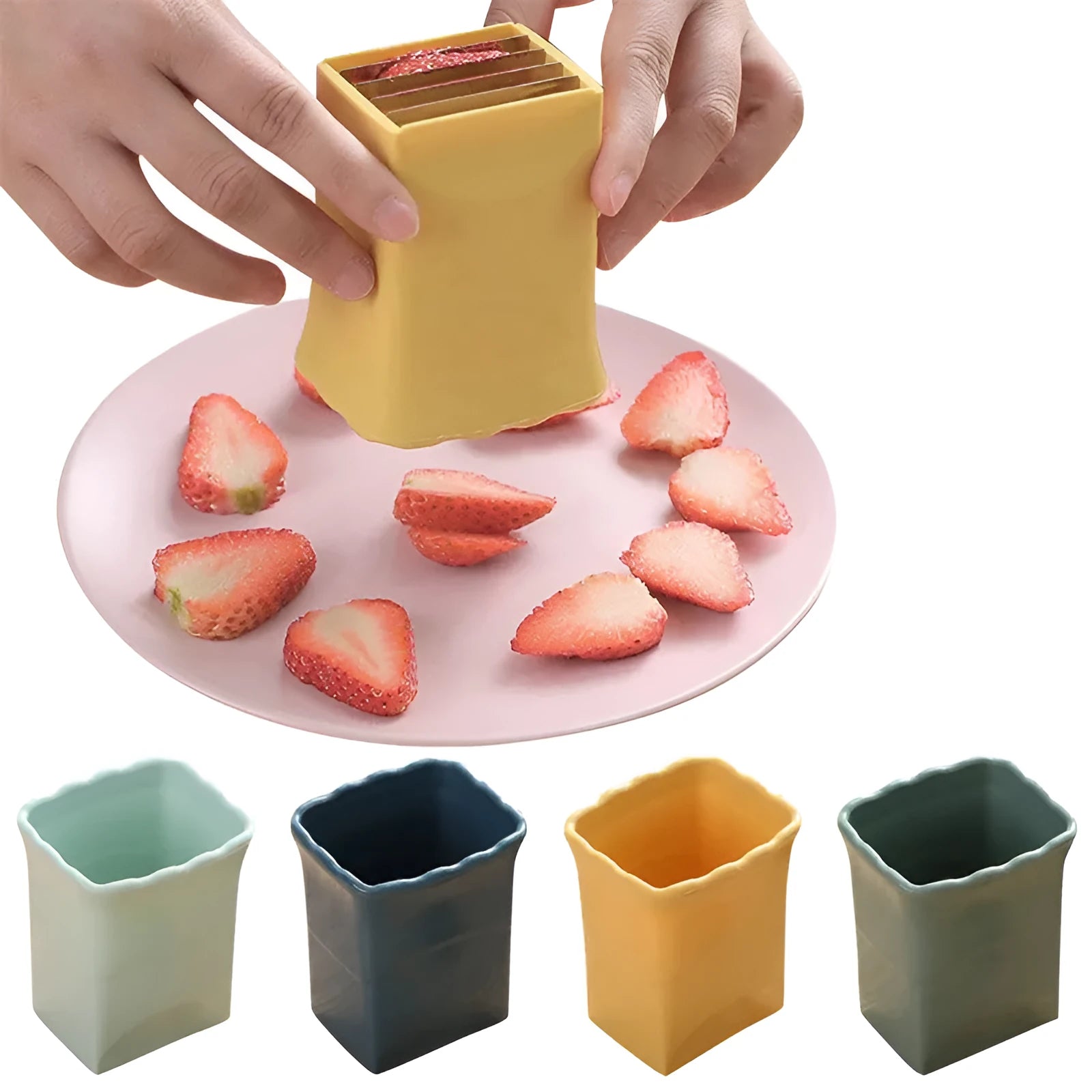 Green stainless steel cup fruit slicer with sliced strawberries on a light background