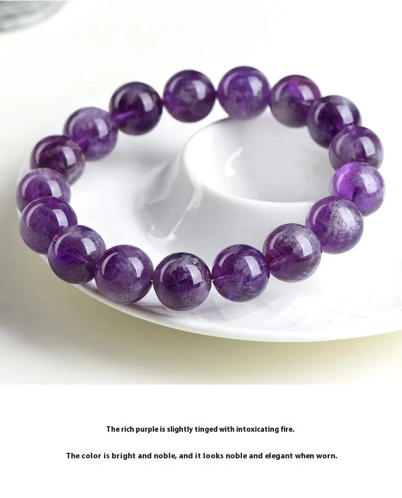 Natural Feather Amethyst purple crystal bracelet with scattered geometric beads on a wrist.