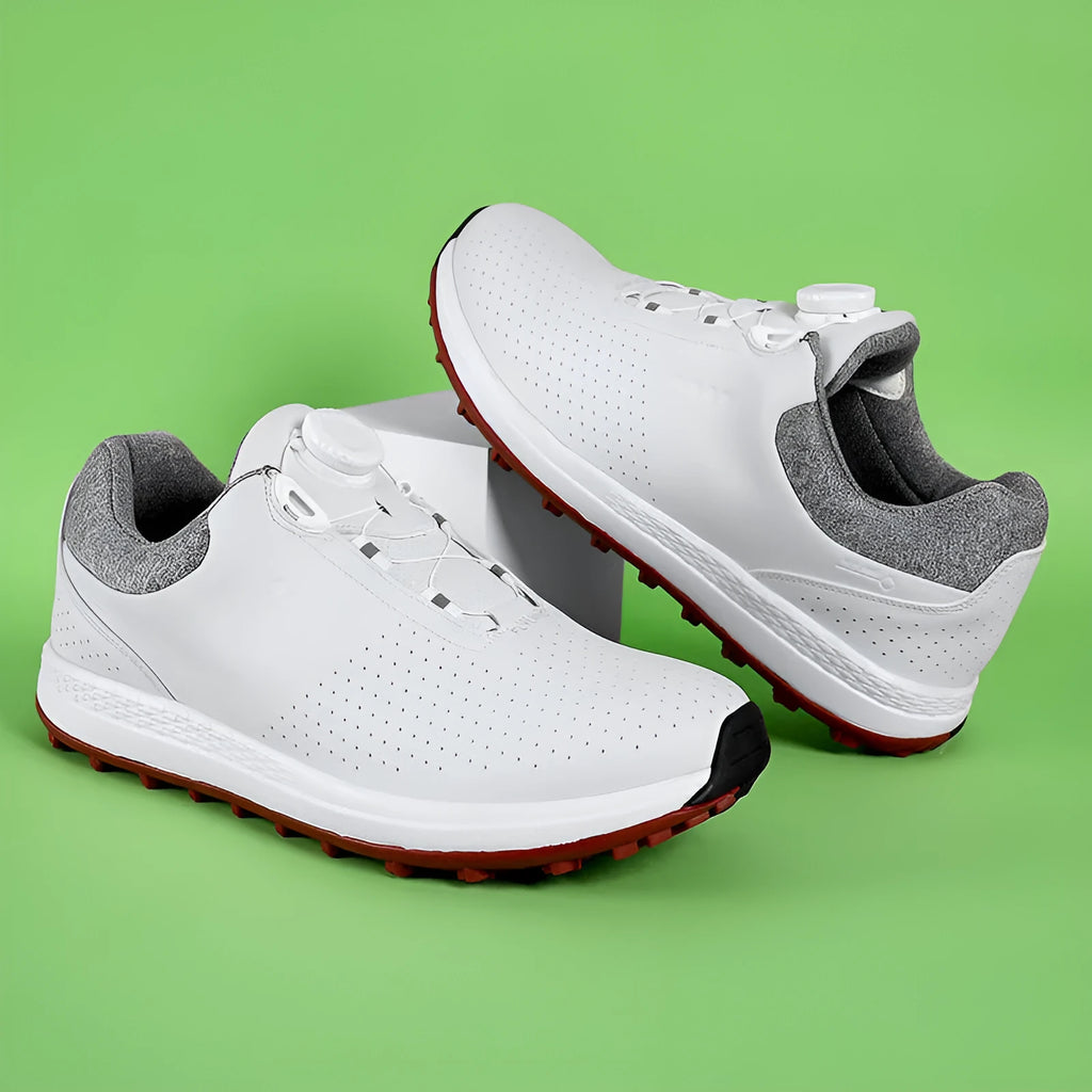 Men's white and black casual low-top golf shoes with breathable upper and traction sole.
