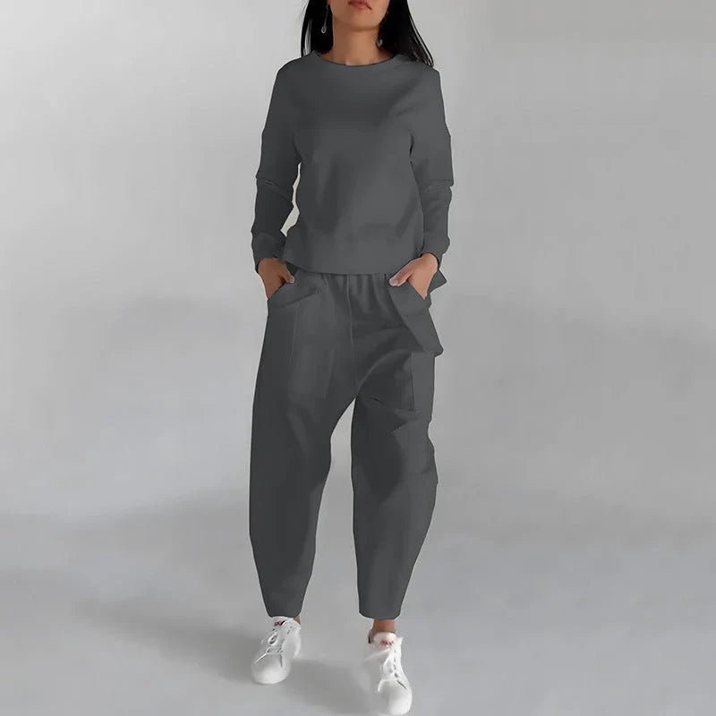 Stylish polyester sweatshirt with unique back slit design and convenient pockets for a fashionable and functional look.