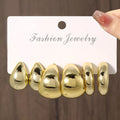 Three pairs of gold, silver, and black acrylic geometric double circle drop earrings set