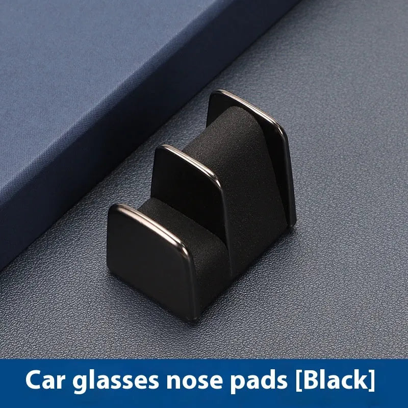 Zinc alloy and leather car dashboard clip for holding sunglasses, shown in green, black, grey, or red.