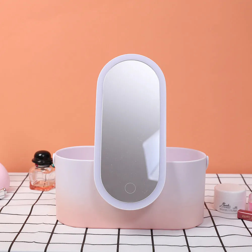 Pink gradient portable LED makeup mirror storage box with open lid showing silver mirror and storage compartment.