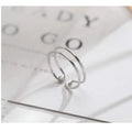 Silver-plated geometric cross ring with an adjustable opening on a copper base.