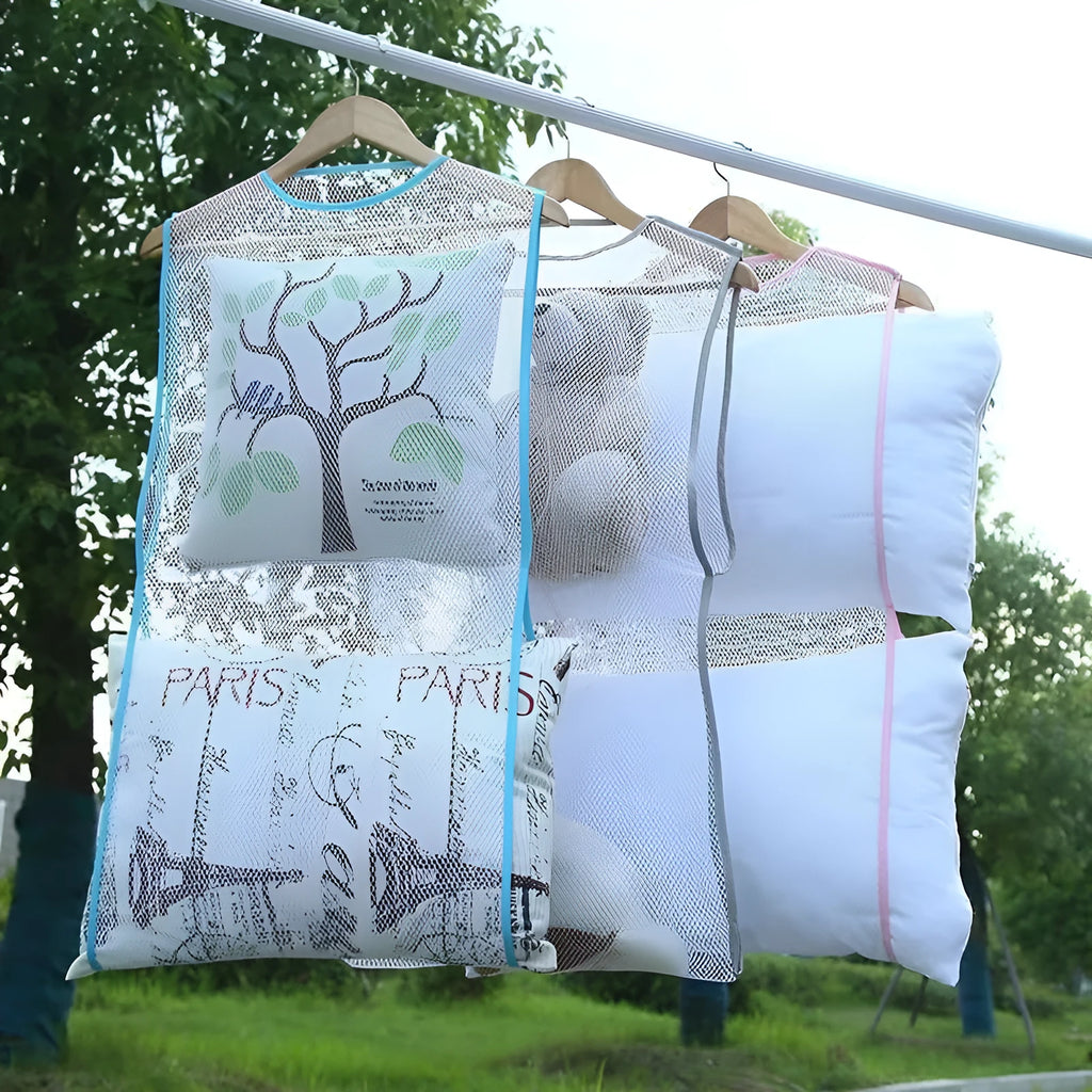 White fabric mesh pillow drying hanger with net pocket on a clothesline outdoors