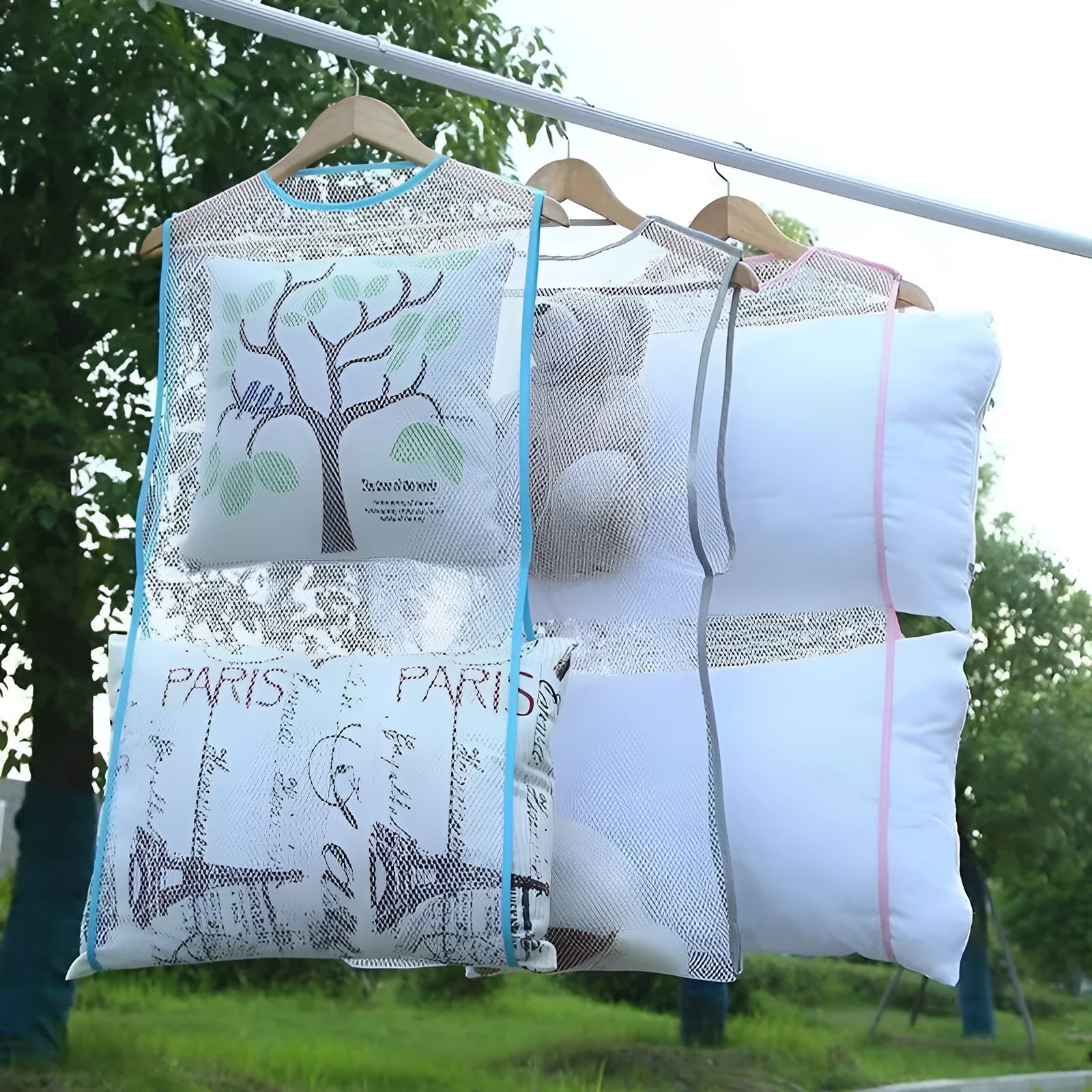 White fabric mesh pillow drying hanger with net pocket on a clothesline outdoors