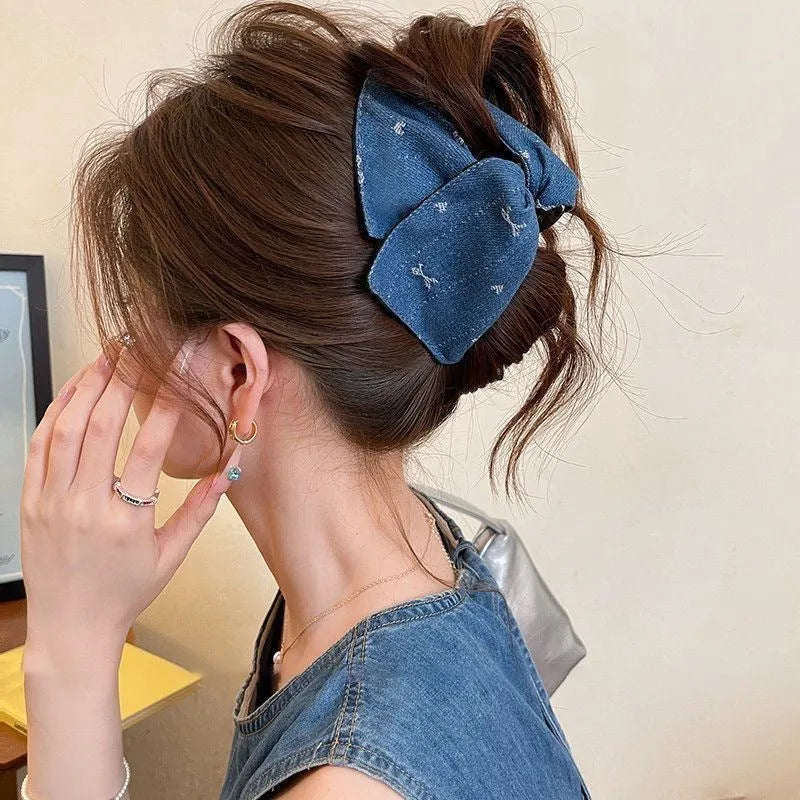 Women's denim bow triangle hair grip with fabric and acrylic details on plastic hairpin