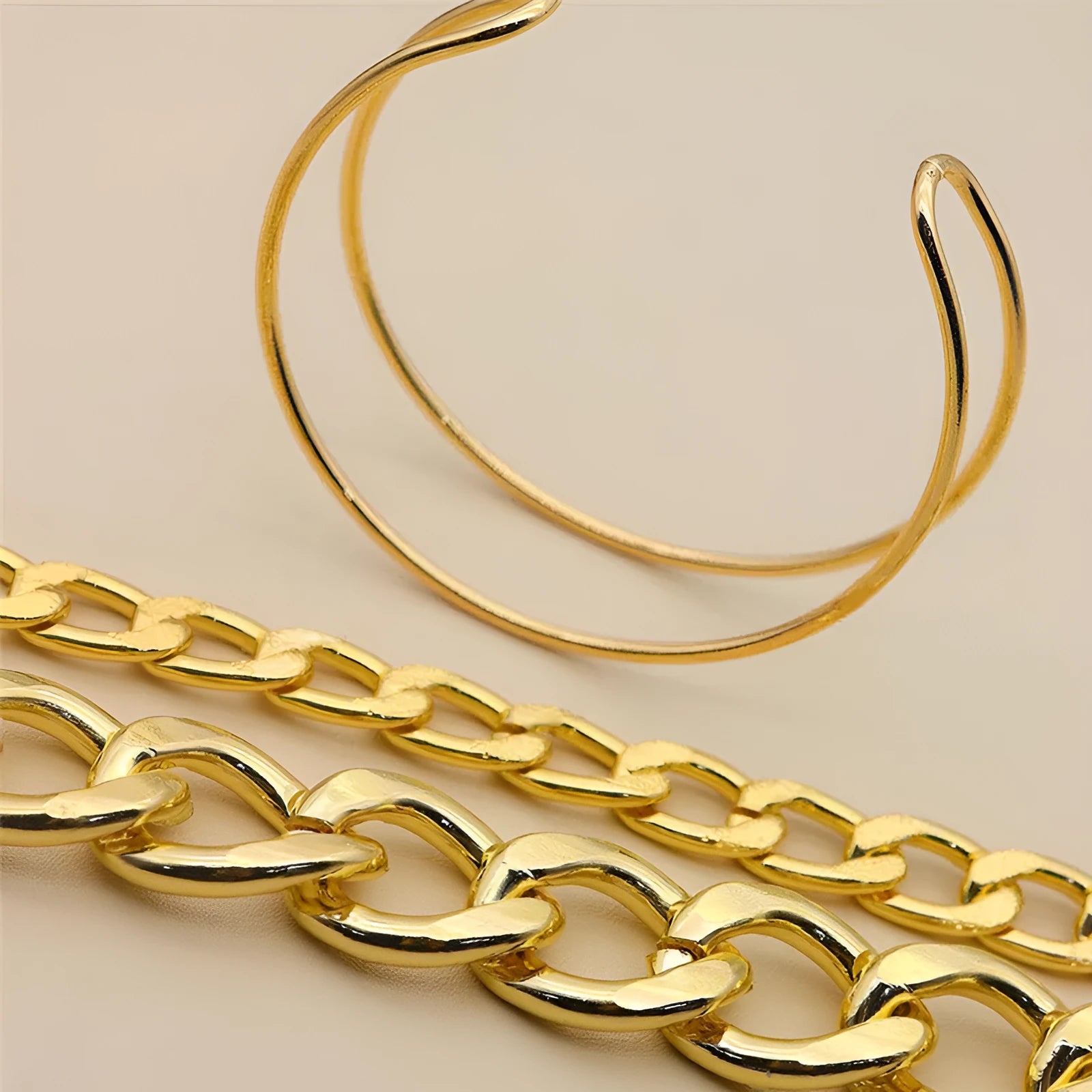 Three gold alloy double-layer thick chain bracelets with geometric design laid out flat