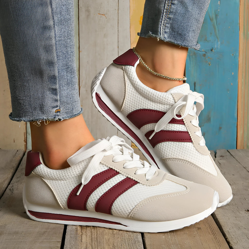 Wine red Cortez retro sneaker with cross strap and breathable mesh surface.