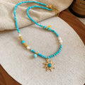 Freshwater pearl necklace with stone sun pendant on clavicle chain, blue or golden pink colour options