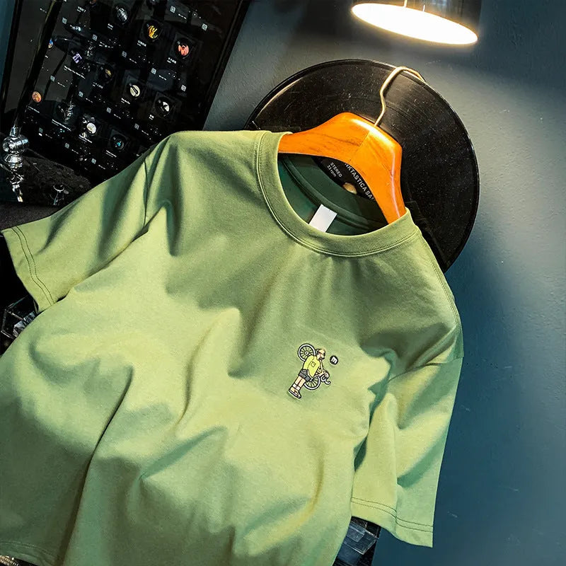 Green loose fit men's short sleeve t-shirt with a printed graphic design on the front.