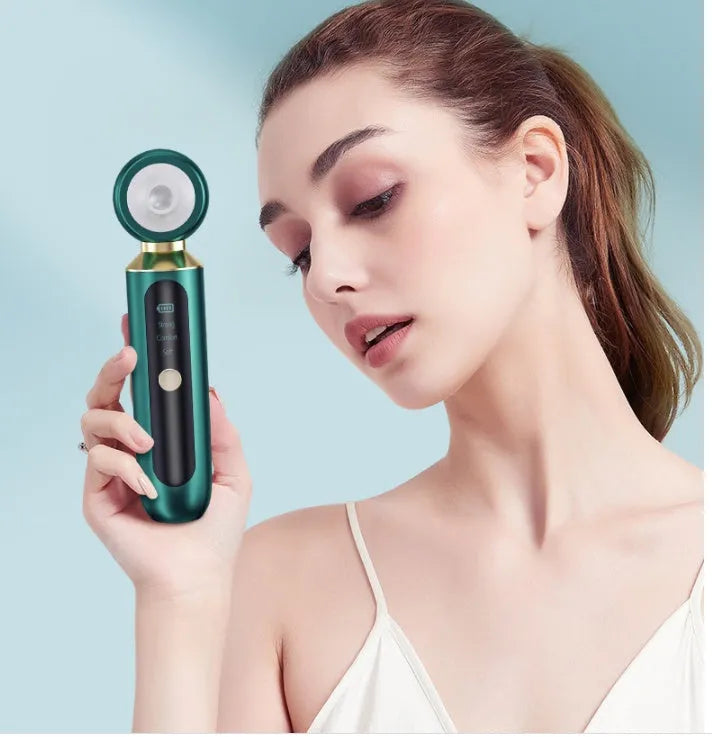 Portable visual blackhead remover with convex lens, three suction tips, and LED light in green