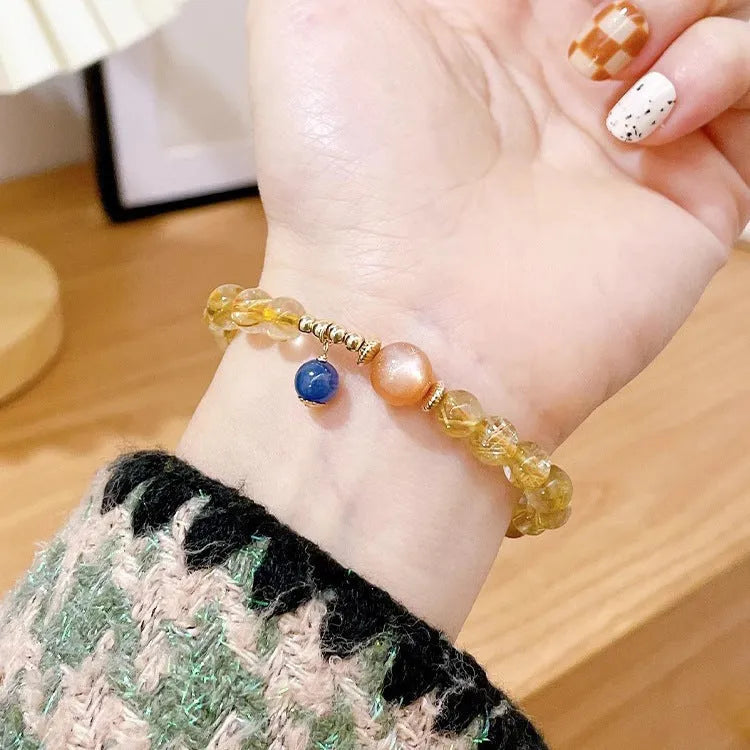 Gold rutilated quartz sunstone bracelet with round beads and diamond-shaped elements