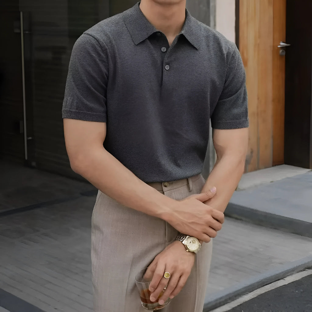 Knitted short-sleeve polo shirt in ice silk cotton fabric on a hanger, showing polo collar detail.