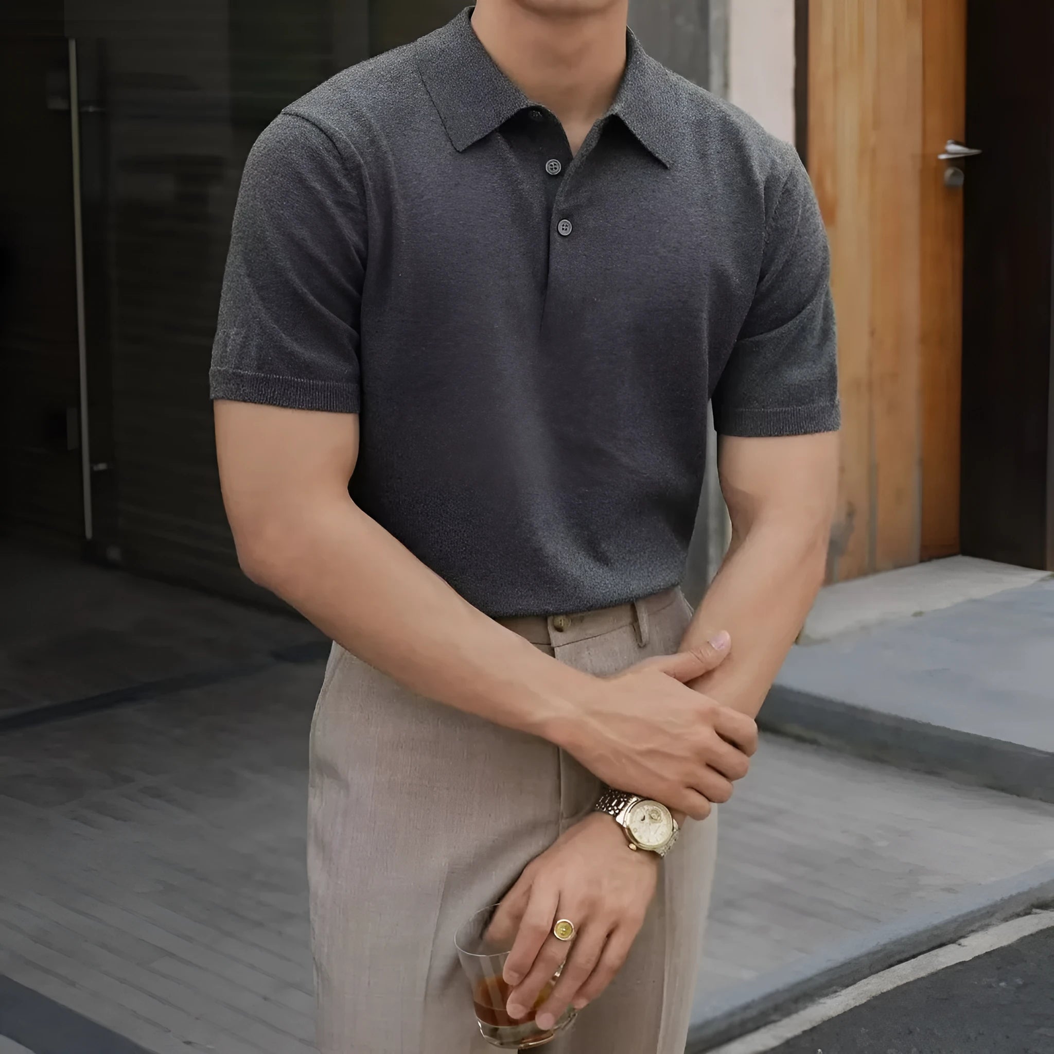 Knitted short-sleeve polo shirt in ice silk cotton fabric on a hanger, showing polo collar detail.
